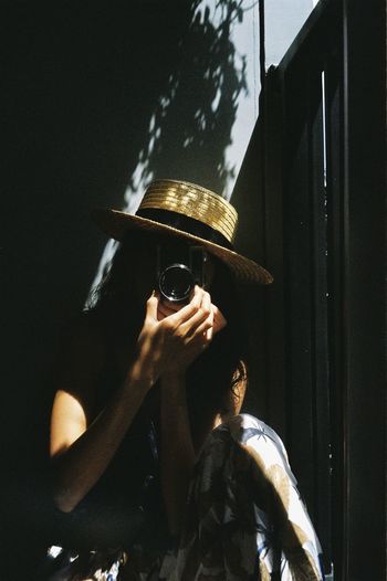 Side view of man wearing hat