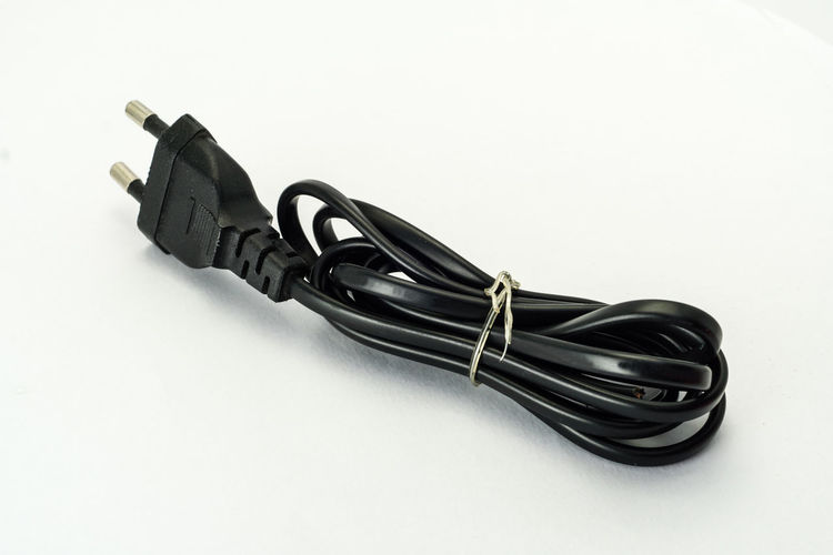Close-up of computer cable over white background