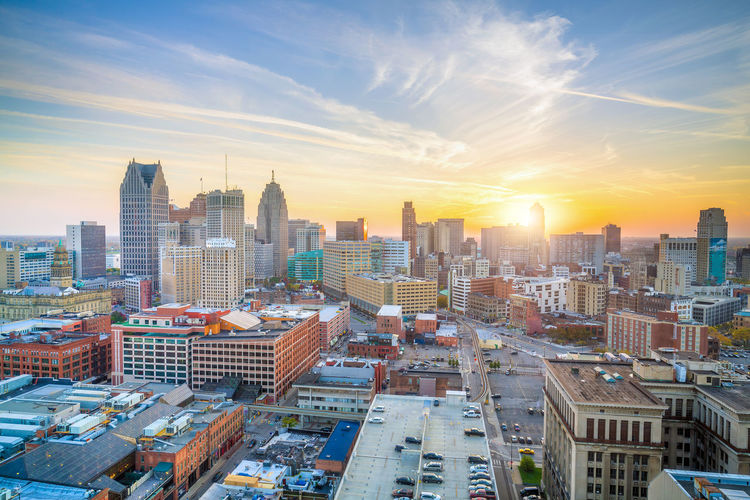 High angle view of modern buildings in city against sky during sunset