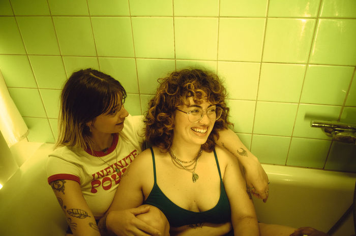 portrait of smiling young woman in bathtub
