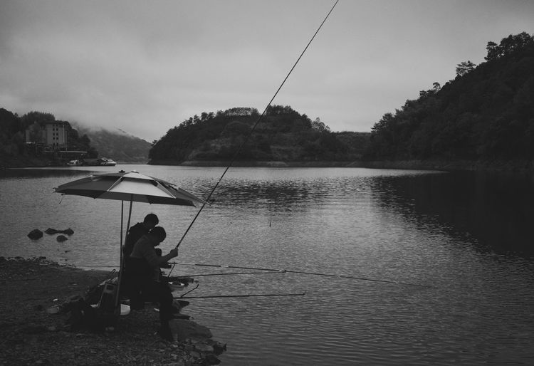 Fishman lake fishing relaxing two man mountain black and whlte