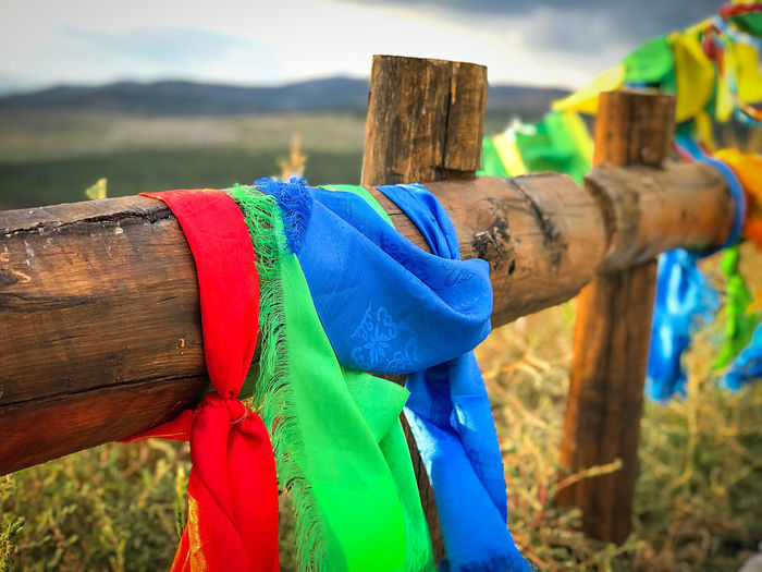 Close-up of multi colored wooden fence on field