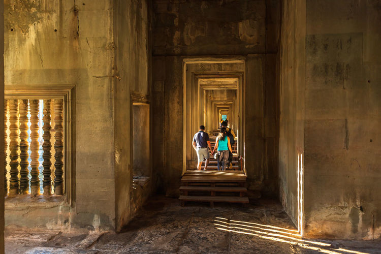 People standing in corridor of building