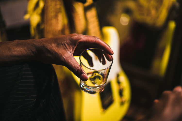 Close-up of human hand holding an empty glass