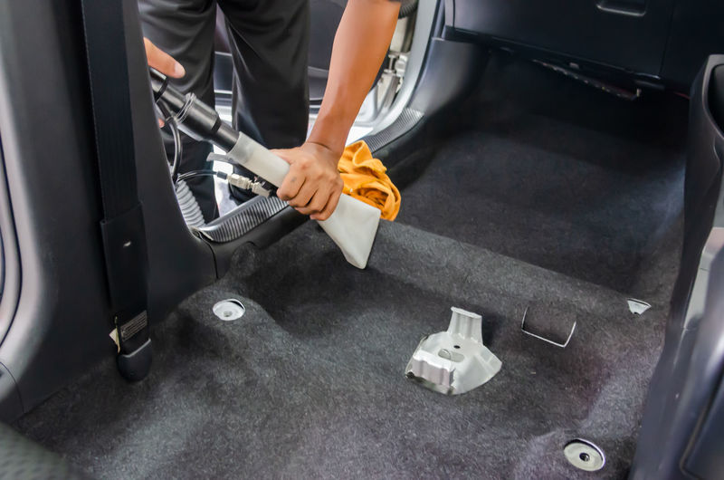Clean the car carpet with a cleaning machine.kill germs with chemicals and dirt in the car.