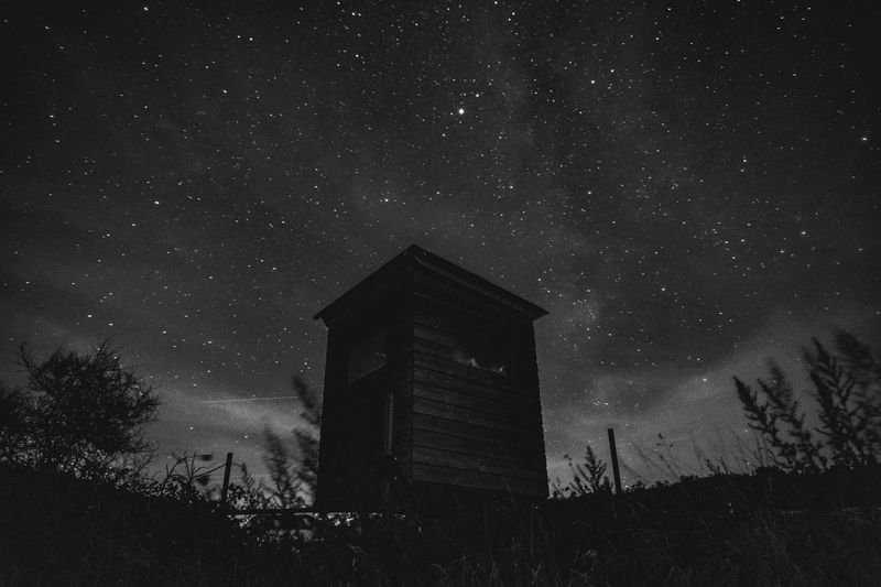 Low angle view of barn against sky at night