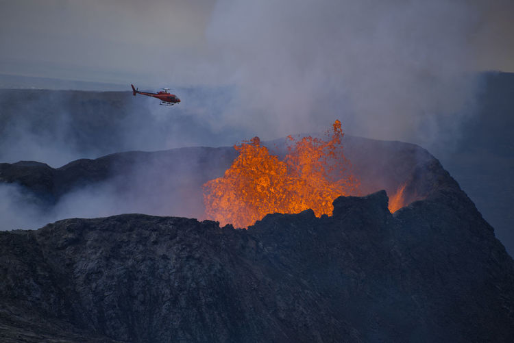Low angle view of lava emitting from volcanic mountain
