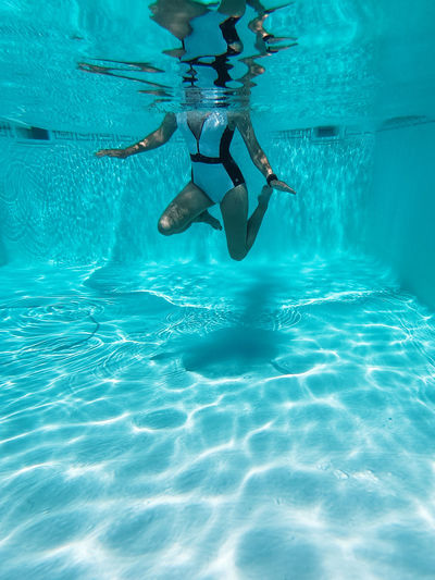 Front view of woman swimming in pool