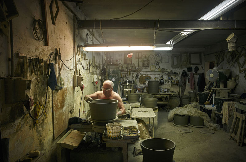 Rear view of man working in workshop