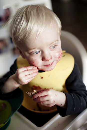 Boy in high chair eating