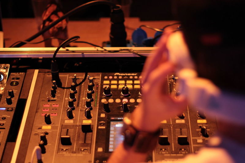 Close-up of club dj with sound mixer