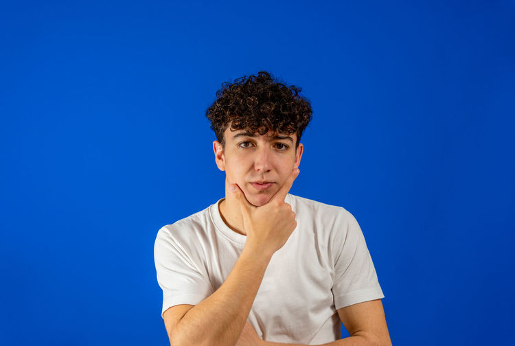 Portrait of mid adult man against blue background