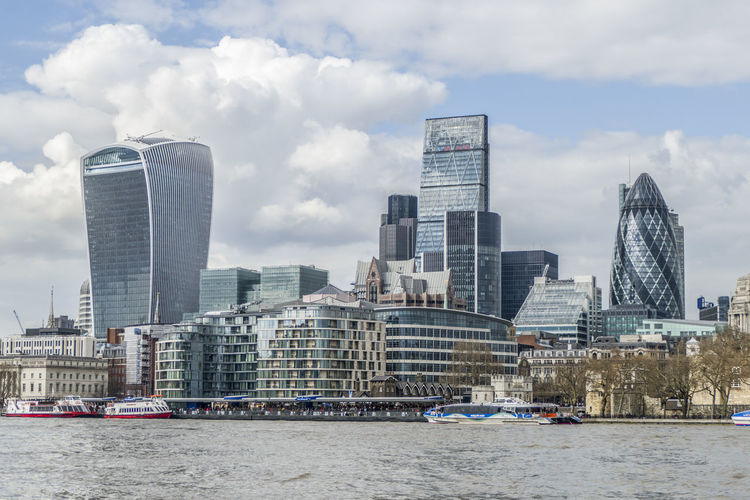 Modern buildings by city against sky