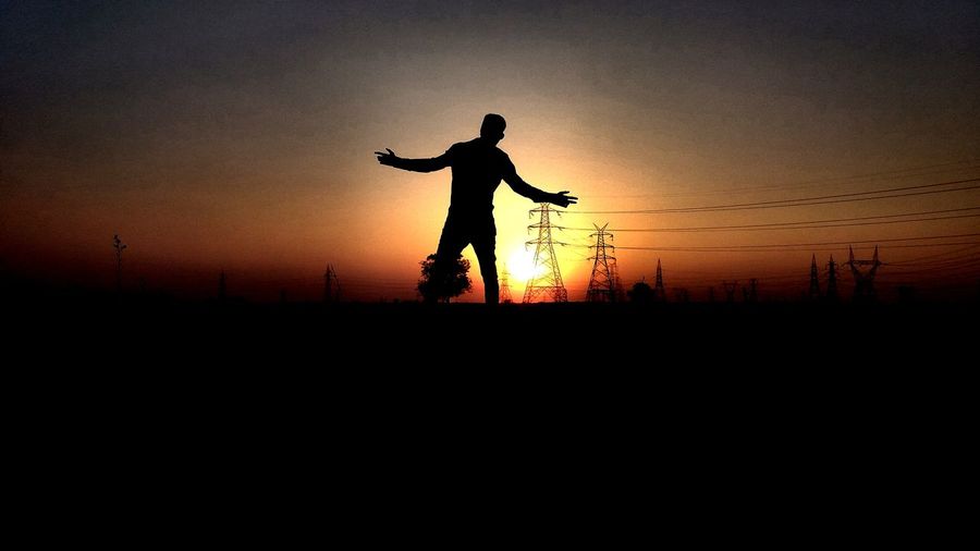 Silhouette man against sky during sunset