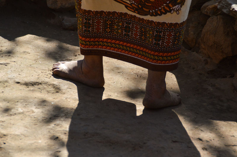 Low section of nepali woman walking barefoot