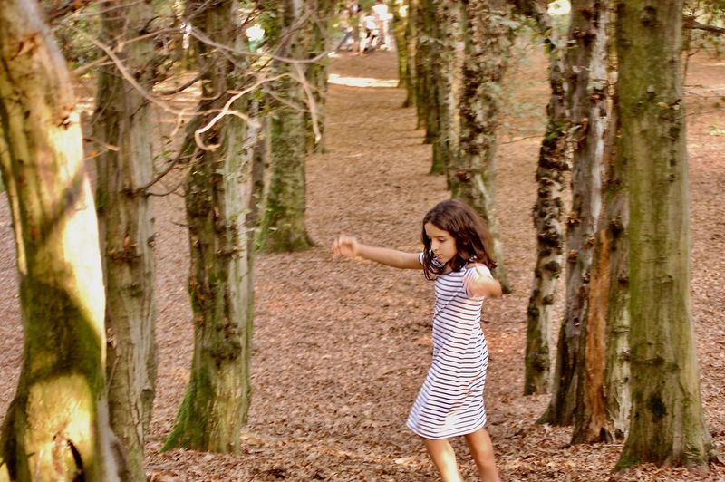Full length of girl walking in forest