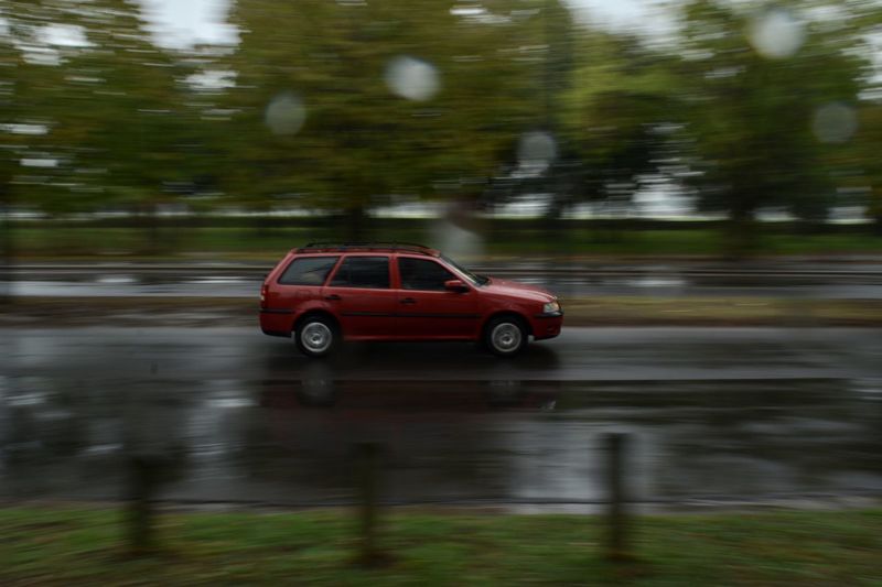 Blurred motion of car on road during rainy season
