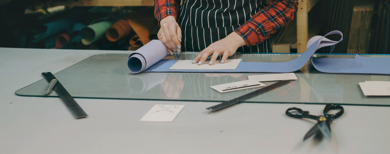 Midsection of man working on table