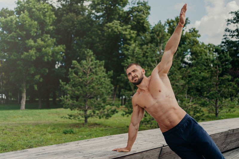 Shirtless man exercising outdoors