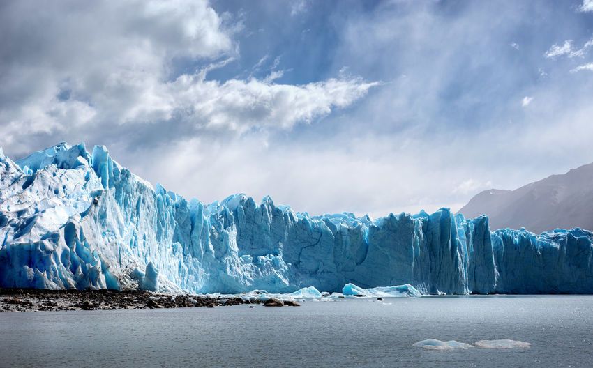 Scenic view of glacier against sky