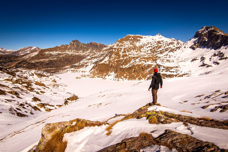 Man hiker contemplate the landscape in mountain time to disconnect concept and healthy lifestyle