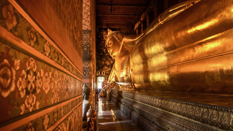 Status of reclining buddha at wat pho temple in thailand