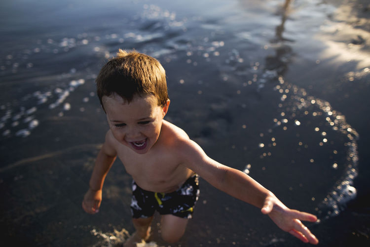 High angle view of boy swimming at beach