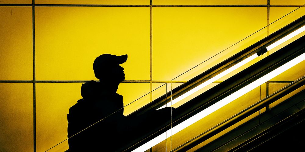 Silhouette of person at railroad station