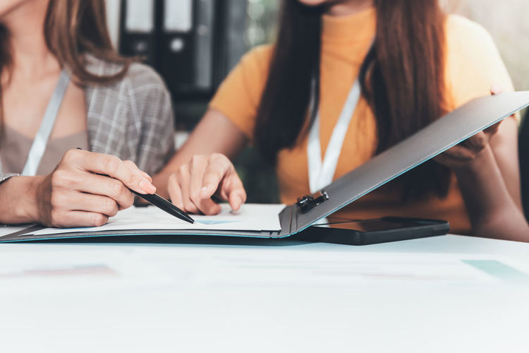 Midsection of woman using laptop on table