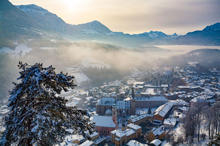 Aerial view of townscape and mountains during winter