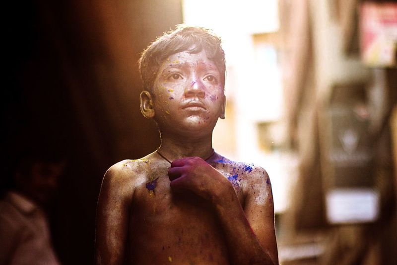 Boy standing outdoors during holi