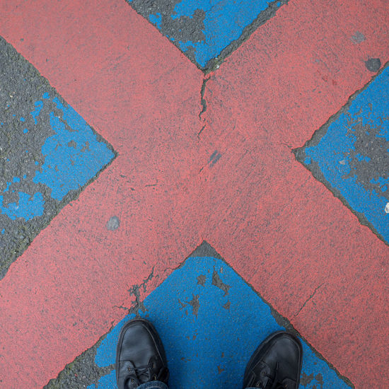 Low section of person standing on tiled floor