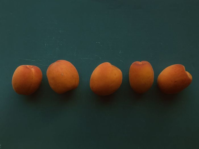 Close-up of oranges on table against black background
