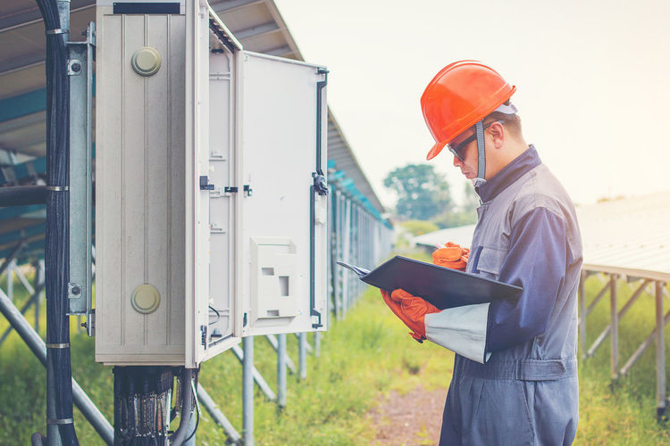 Manual worker examining machinery