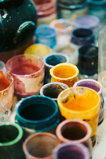 Glass cups with paints in workshop