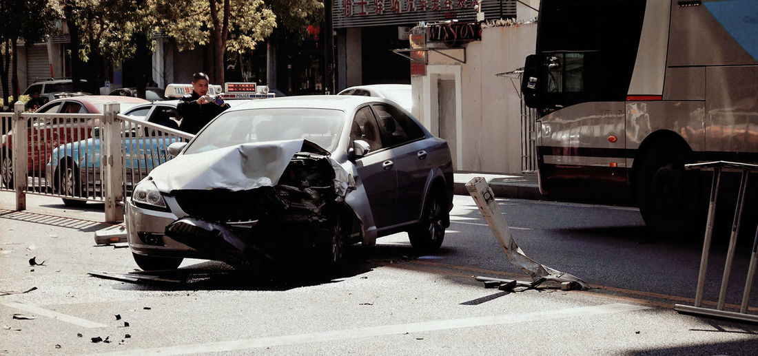 Man taking picture of damaged car