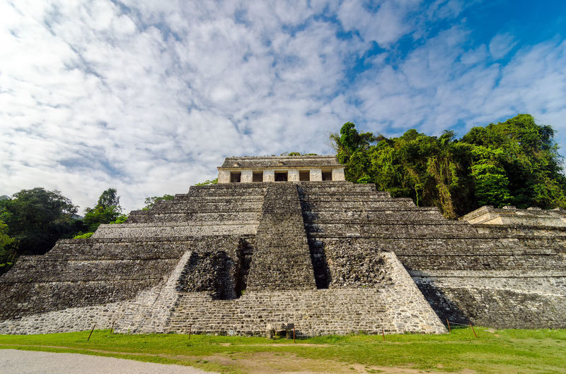 Low angle view of old ruins against cloudy sky
