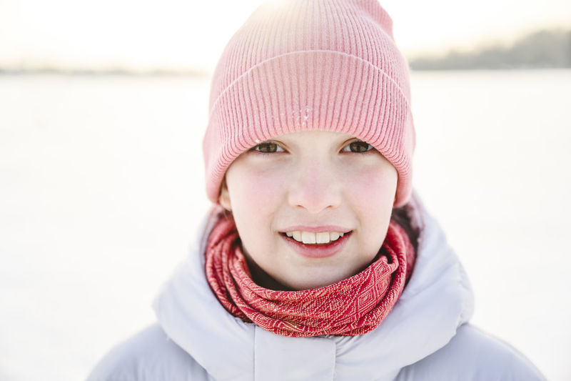 Happy girl wearing knit hat in winter