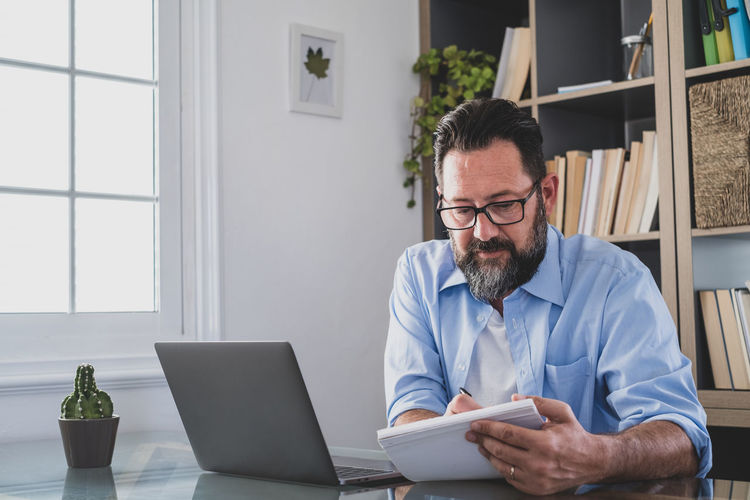 Young man using laptop while sitting at office