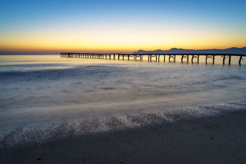 Scenic view of beach against sky during sunset