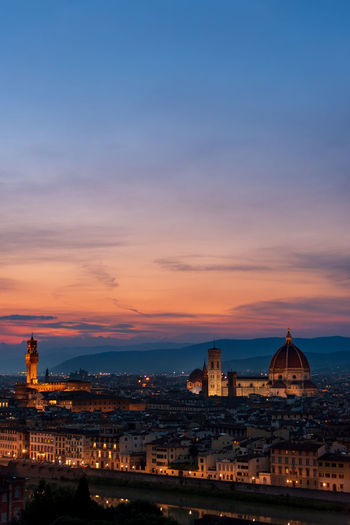 Florence sunset with lungarno, the cathedral and palazzo vecchio illuminated