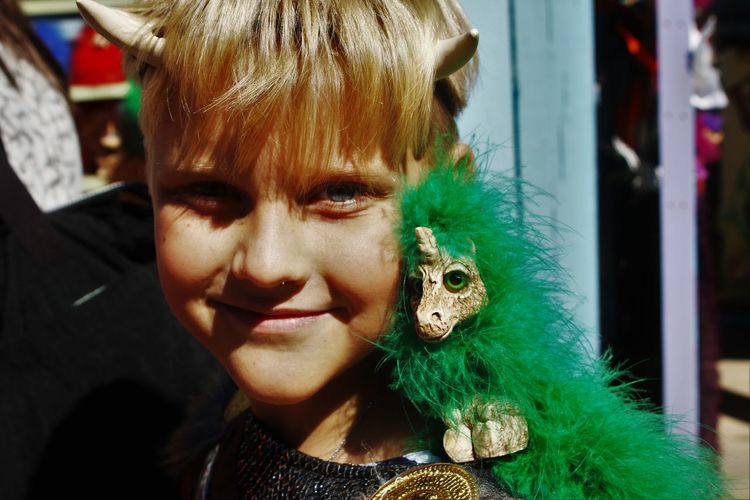 Portrait of young boy with toy dragon