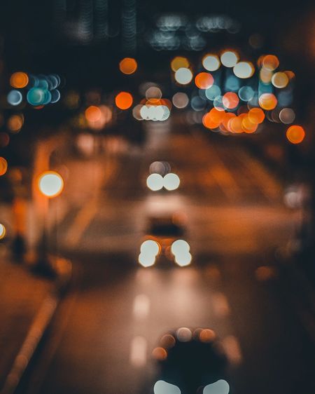 Defocused image of illuminated street at night