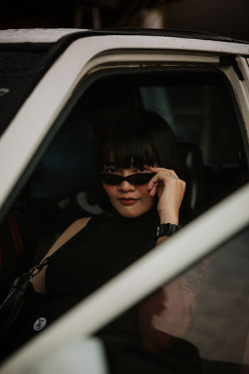Portrait of woman sitting in car