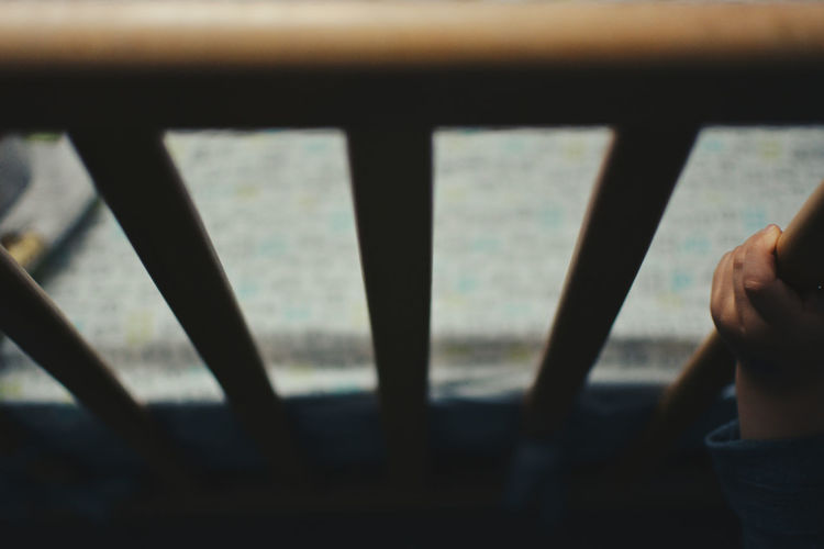 Cropped hand of child holding crib