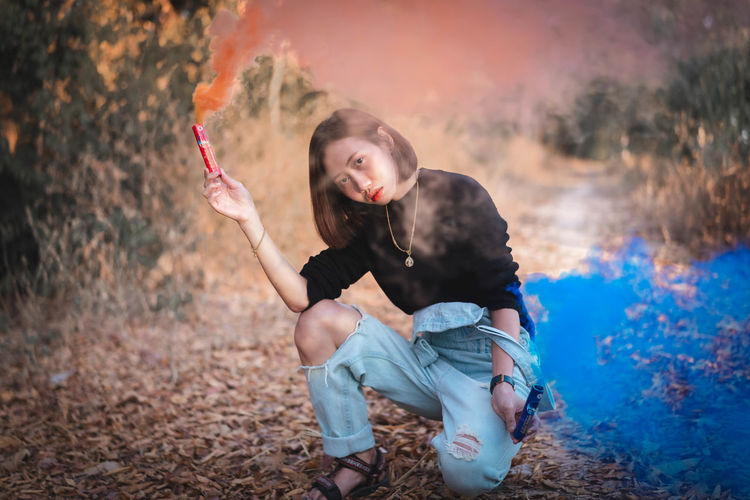 Portrait of woman holding distress flare
