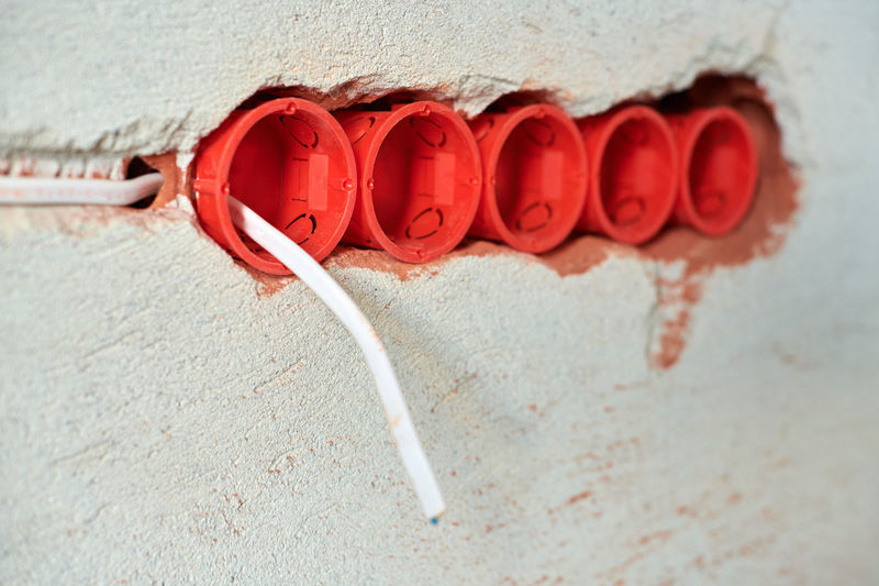 Close-up of red pipe on wall