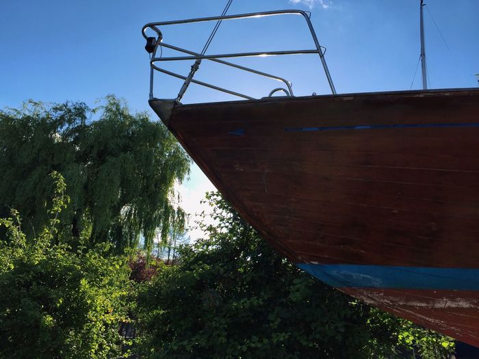 Low angle view of boat moored against sky