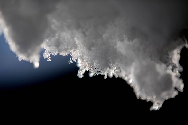 Close-up of snow against sky at night