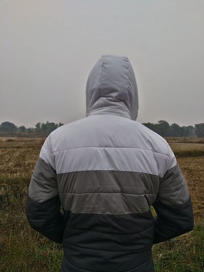Rear view of man standing on field